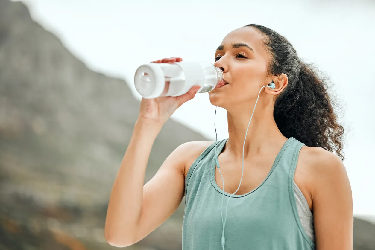 mujer bebiendo agua de una botella